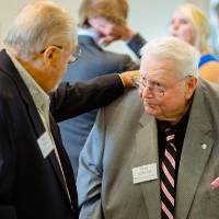Seymour Padnos putting his hand on a guest's shoulder at the Foundation Annual Meeting